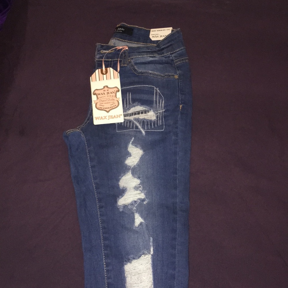 Wax distressed denim jeans